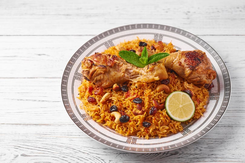 Kabsa at white wooden background. Kabsa is traditional saudi arabian cuisine dish.